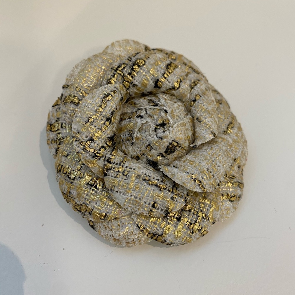 White and golden brooch
